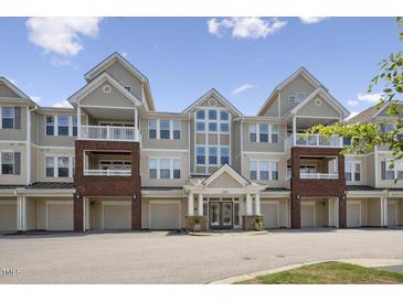 Attractive multi-story condo building featuring garages, balconies, and a welcoming entrance under a clear sky at 2810 Bedford Green Dr # 5, Raleigh, NC 27604