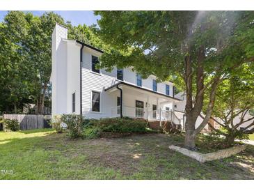 Charming two-story home with a welcoming front porch and well-maintained landscaping at 3421 Tunas St, Raleigh, NC 27616