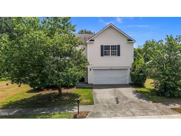 Two story home featuring a large front yard, attached garage, and lovely curb appeal at 4716 Miller Dr, Durham, NC 27704