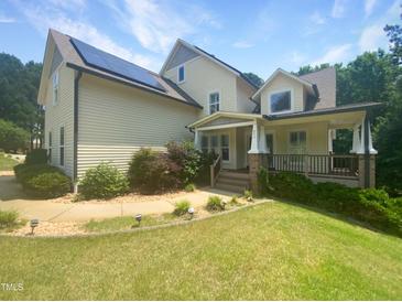 Charming two-story home with solar panels and a covered front porch at 495 Ruth Cir, Fuquay Varina, NC 27526