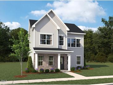 Charming two-story home with vertical siding, a brick-clad porch, and lush landscaping at 2864 Quarry Rd # 168, Rolesville, NC 27571