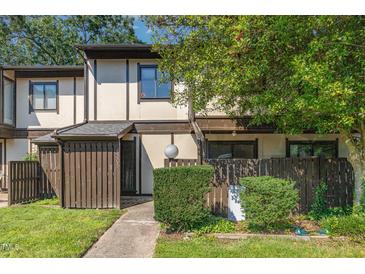Charming townhouse featuring neutral tones, a fenced front yard, and a walkway leading to the entrance at 4305 Lake Ridge Dr, Raleigh, NC 27604