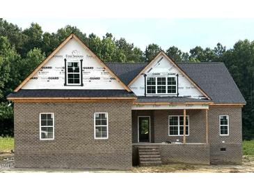 Charming brick home featuring a covered porch and classic design, showcasing quality craftsmanship at 7351 Twin Pines Rd, Spring Hope, NC 27882