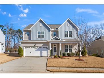 Charming two-story home featuring a two-car garage and beautifully landscaped front yard at 78 N Porcenna Ln, Clayton, NC 27527