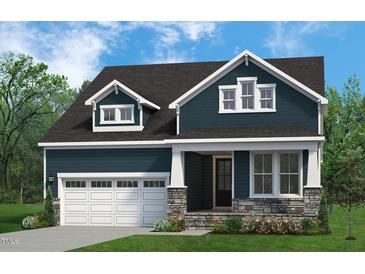 Charming two-story home with a dark blue exterior, stone accents, white trim, and well-manicured lawn at 816 Ballaster Rd, Fuquay Varina, NC 27526