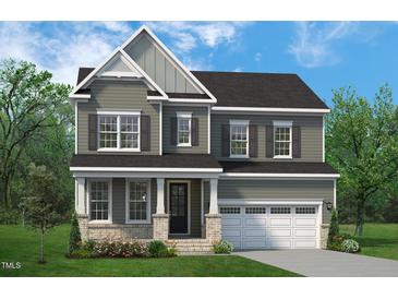 Charming two-story home with a two-car garage, elegant siding, and a welcoming front porch at 824 Ballaster Rd, Fuquay Varina, NC 27526