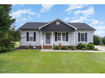 Charming single-story home features a well-manicured lawn and inviting front porch at 11 Sherman Rd, Fuquay Varina, NC 27526