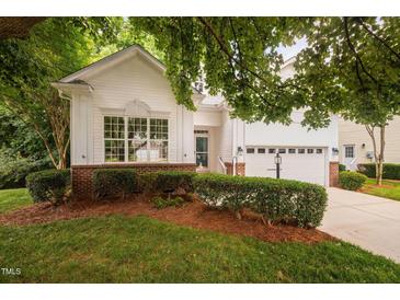 Charming home featuring manicured landscaping, a two-car garage, and a welcoming entrance at 208 Rockport Ridge Way, Cary, NC 27519