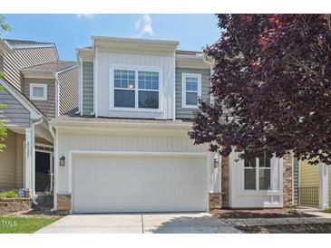Two story home boasts a two car garage and manicured landscaping at 2323 Pindos Dr, Cary, NC 27519