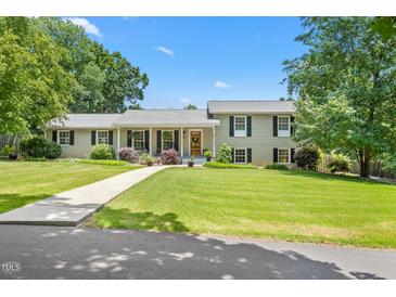 Charming home with a well-manicured lawn and inviting walkway leading to the covered front porch at 2816 Keck Dr, Burlington, NC 27215