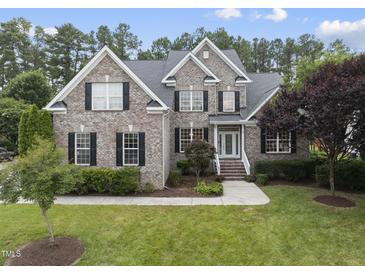 Charming two-story brick home with black shutters and lush landscaping at 501 Ivyshaw Rd, Cary, NC 27519