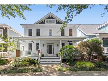 Charming two-story home featuring a welcoming front porch and beautifully landscaped front yard at 10570 Evergreen Spring Pl, Raleigh, NC 27614