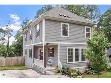 Charming two-story home featuring a welcoming front porch and beautifully landscaped front yard at 1304 Castlebay Rd, Durham, NC 27703