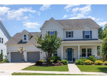 Charming two-story home featuring a well-manicured lawn, attached garage, and welcoming front porch at 1502 Spring Overlook Ln, Hillsborough, NC 27278