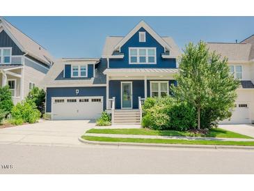 Charming navy blue home featuring a two-car garage and beautifully landscaped front yard at 41 Highveld Ave, Chapel Hill, NC 27516