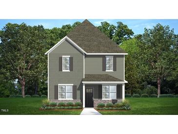 Charming two-story home featuring a mix of siding textures and welcoming front porch at 561 Lemon Daisy Ln, Knightdale, NC 27545