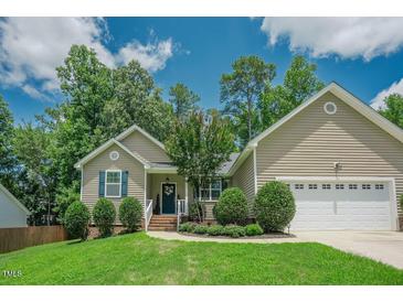 Charming single-Gathering home featuring a manicured lawn, tasteful landscaping, and a welcoming front porch at 90 Weatherly Dr, Franklinton, NC 27525