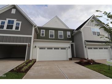 Charming new construction home featuring attached garages and manicured landscaping at 920 Montague Ave, Durham, NC 27703