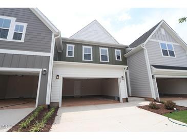 Attached garages with carriage doors provide convenient parking and complement the architectural style of the homes at 920 Montague Ave, Durham, NC 27703