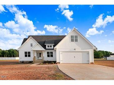 Charming two-story home with a two-car garage, dark roof, and light-colored siding at 9427 Turkey Way, Middlesex, NC 27557
