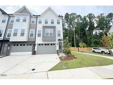 Modern townhome with a two-car garage, neutral color scheme and well-maintained landscaping at 1015 Regalia Rd # 27, Durham, NC 27713