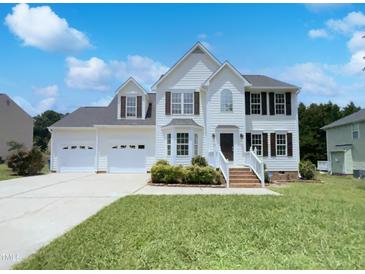 Charming two-story home featuring a three-car garage, manicured lawn and inviting front porch at 17 Ballard Ct, Durham, NC 27712