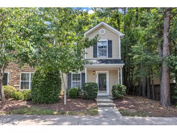 Charming two-story home with tan siding, lush landscaping, and a welcoming front entrance at 3352 Tarleton W, Durham, NC 27713