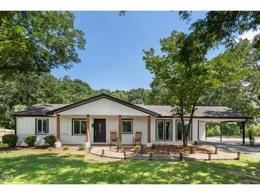 Charming ranch home with a brick facade, covered entrance, and well-manicured lawn at 6005 Lake Wheeler Rd, Raleigh, NC 27603