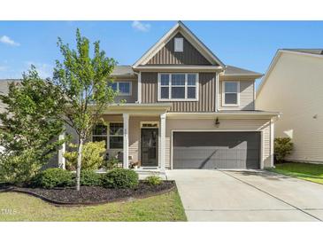 Charming two-story home featuring a well-manicured lawn and a two-car garage in a desirable neighborhood at 634 Stapleford Ln, Fuquay Varina, NC 27526