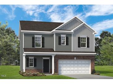 Charming two-story home featuring gray siding, black shutters, and an attached two-car garage at 88 Freedom Heights Ln # 148, Smithfield, NC 27577