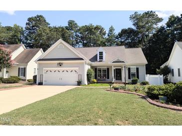 Charming single-story home featuring a two-car garage, well-manicured lawn, and inviting landscaping at 904 E Ivy Valley Dr, Fuquay Varina, NC 27526