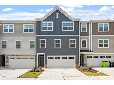 Beautifully designed townhome featuring modern architecture and well-maintained landscaping at 1114 Crossvine Trl, Durham, NC 27703