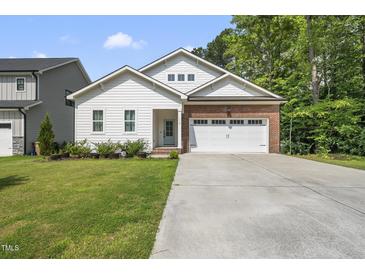 Charming single-Gathering home with a well-manicured lawn and a brick and siding facade at 112 Lager Ln, Garner, NC 27529
