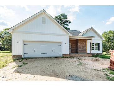 Charming new construction home featuring white siding, brick accents, and an attached two-car garage at 1229 Lawndale Dr, Graham, NC 27253