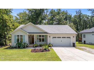 Charming single-Gathering home with tidy landscaping, a two-car garage, and delightful curb appeal at 174 Sequoia Dr, Louisburg, NC 27549