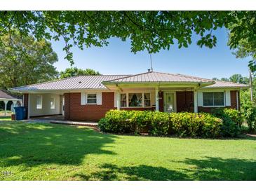 Charming one-story brick home with lush green lawn and covered porch at 2081 Stone Street Ext, Mebane, NC 27302