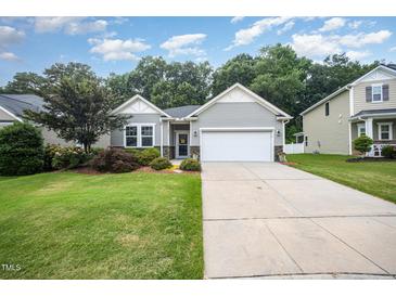 Charming single-story home with a well-manicured lawn and a two-car garage at 3037 Willow Ranch Dr, Fuquay Varina, NC 27526
