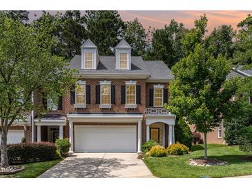 Charming brick townhome featuring a two-car garage and well-maintained landscaping in a desirable neighborhood at 4060 Barton Park Pl, Raleigh, NC 27613
