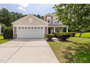 Charming home with a two-car garage, manicured landscaping, and a welcoming front porch at 4205 Twin Spires Dr, Knightdale, NC 27545