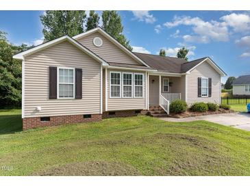 Charming single-story home with a well-maintained lawn and welcoming front porch at 432 Barn View Ct, Fuquay Varina, NC 27526
