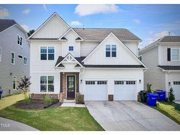 Charming two-story home with a well-manicured lawn and a two-car garage at 533 Kings Lake Way, Durham, NC 27703