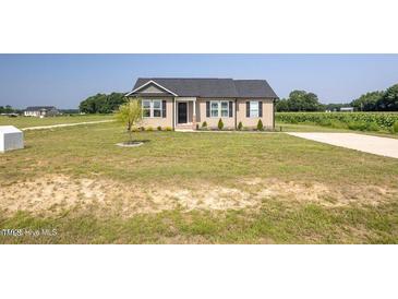 Charming single-story home with well-maintained lawn and landscaping at 82 Mamie Rd, Benson, NC 27504