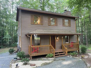 Charming two-story home with a covered front porch, wood siding, and well-maintained landscaping at 1012 King Cir, Chapel Hill, NC 27516