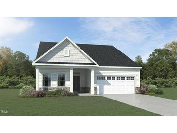 Charming single-story home featuring stone accents, a two-car garage, and a well-manicured lawn at 1102 Red Roses Ave, Durham, NC 27703
