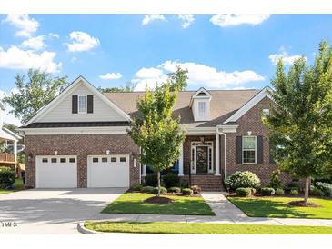 Charming brick home with a well-manicured lawn, two-car garage and inviting front entrance at 1217 Clandon Square Rd, Hillsborough, NC 27278