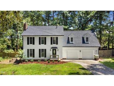 Charming two-story home with black shutters, new roof and manicured lawn at 1609 Falls Ct, Raleigh, NC 27615