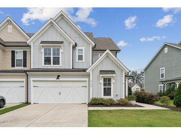 Charming two-story townhome with attached two-car garage and beautifully landscaped front yard at 3194 Retama Run, New Hill, NC 27562