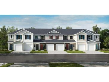 New townhomes with attached garages feature classic architectural details and neutral color schemes at 507 Eastwood St, Durham, NC 27704