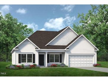 Charming single-story home with a white exterior, complemented by a well-manicured lawn and inviting curb appeal at 522 Olivia Crossing Ct # 18, Four Oaks, NC 27524