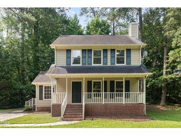 Charming two-story home featuring blue shutters and a cozy front porch, creating a welcoming curb appeal at 5429 Fortunes Ridge Dr, Durham, NC 27713